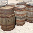 Reclaimed oak whisky barrels showing the shrunken staves and loose iron hoops due to an extended heatwave in Britain in summer 2026