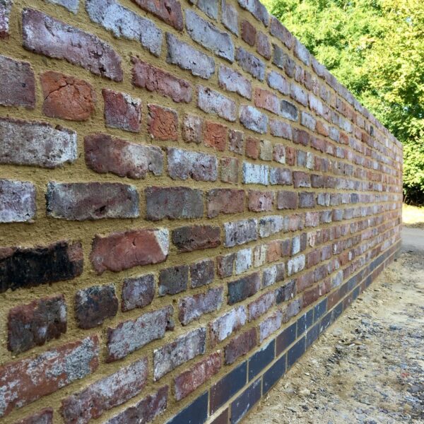 Reclaimed Tudor era bricks reused in a wall