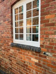 Reclaimed blue bullnose bricks as a windowsill