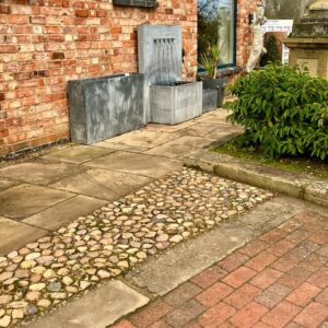 A variety of hard landscaping including flagstones, cobbles, paving bricks and kerbs