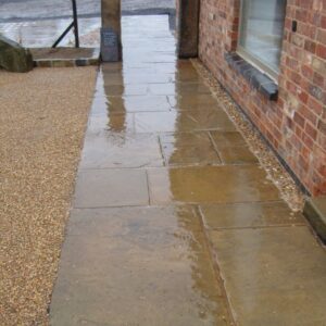 Reclaimed buff Yorkstone flags laid as a path