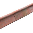 Reclaimed red clay roll top ridge tiles with a light patina