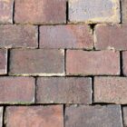 Wet Staffordshire Blue paving bricks showing smooth worn faces and weathered patina, recovered from a large garden near Tiffield, Northamptonshire