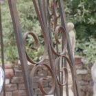 Reclaimed antique wrought iron gazebo detail, showing a rich weathered patina.