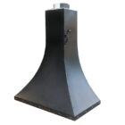 A reclaimed black steel fireplace hood, showing signs of use only at the top flue