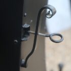 Detail of the black steel fireplace hood showing the flue adjuster