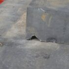 Detail of the drip channel in a batch of blue/grey concrete wall coping.