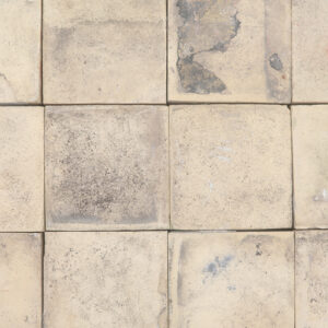Reclaimed traditional buff Norfolf pamment tiles showing an authentic weathered face and remnants of mortar and lino flooring