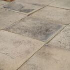 Reclaimed traditional buff Norfolk pamment tiles showing authentic weathering.