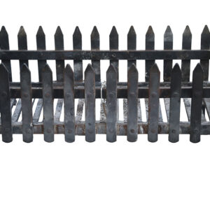Fence style fire basket showing weathering from prior use and sturdy cast iron construction