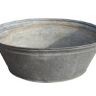 Large reclaimed galvanised metal tub or planter showing an aged patina and signs of prior use.