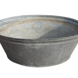 Large reclaimed galvanised metal tub or planter showing an aged patina and signs of prior use.