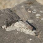 Detail of iron handrail on a granite step from a bridge near Winslow in Buckinghamshire