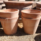 Plain tall terracotta pots from Italy showing the terracotta finish