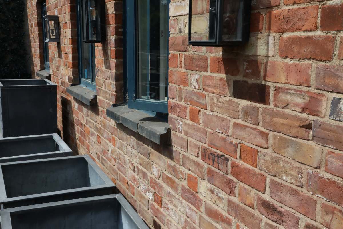 A house wall constructed of reclaimed bricks and lime mortar