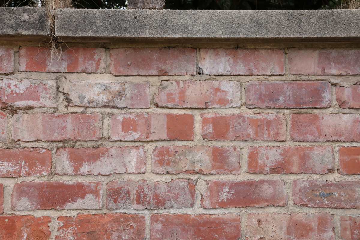 A retaining wall constructed of reclaimed bricks and lime mortar, in keeping with the period nature of the environment