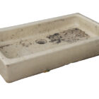A reclaimed cream glazed shallow Butler sink showing a weathered patina and the minor chips of age and use