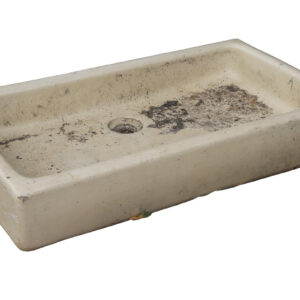 A reclaimed cream glazed shallow Butler sink showing a weathered patina and the minor chips of age and use