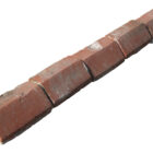 Reclaimed red plinth stretcher bricks laid out in a line, and showing the weathered surfaces and remnants of mortar