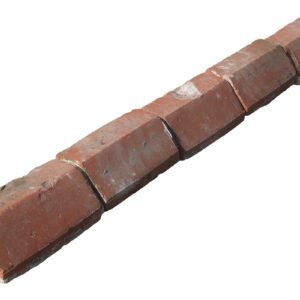 Reclaimed red plinth stretcher bricks laid out in a line, and showing the weathered surfaces and remnants of mortar