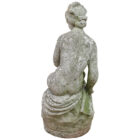 A reclaimed and weathered statue of the classical mythological figure of Andromeda