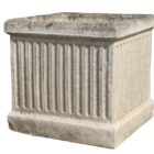 A reclaimed Willowstone composite stone planter with classical fluted sides and a weathered patina