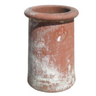 A red, reclaimed roll top chimney pot whith patchy white pain, mild discolouration and minor patches of lichen.