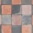 A batch of reclaimed handmade red and blue 9" quarry tiles showing a weathered patina