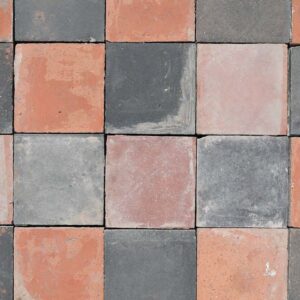 A batch of reclaimed handmade red and blue 9" quarry tiles showing a weathered patina
