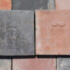The reverse side of 9" red and blue handmade quarry tiles from a large single batch of 36sqm