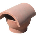 A terracotta cowled chimney pot or flue cap showing minor chips from years in storage