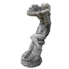 A composite stone birdbath depicting a cherub holding a shell and displaying a fabulous weathered patina
