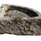 A rustic, hand carved antique Yorkstone corner sink with a rich patina and tell tale signs of hand carving in the rough chisel marks