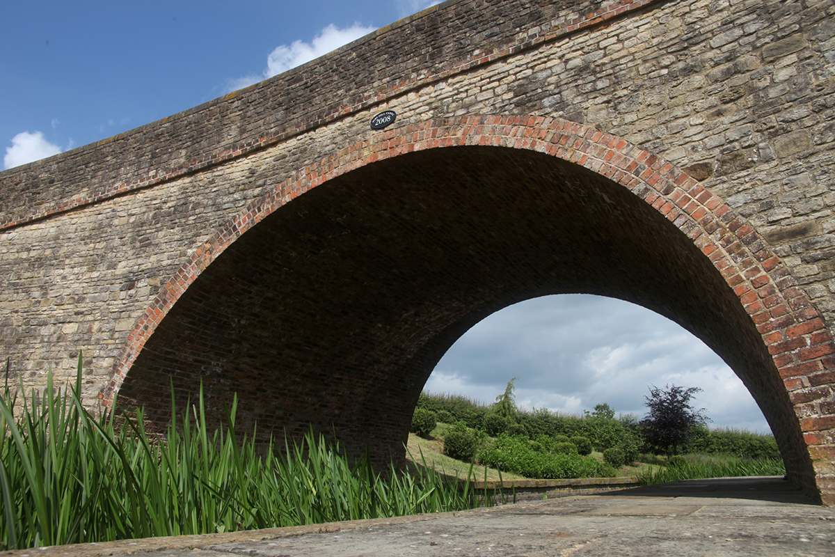 Architect designed bridge built in 2008 with materials from reclamation yards and subsequently finished by sustainably focused landscapers