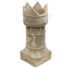 A reclaimed buff earthenware chimney pot with a crown top, showing an age worn patina and one broken palisade, or point