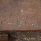 A 3 ton vintage cast iron calibration weight marked with the imperial equivalent weight and showing a fantastic patina