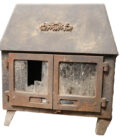 A reclaimed Hunter Herald 4 Mk1 log burning stove with cast iron doors and a heavy used patina