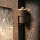 Detail of a reclaimed Hunter Herald 4 Mk1 log burning stove with cast iron doors and a heavy used patina