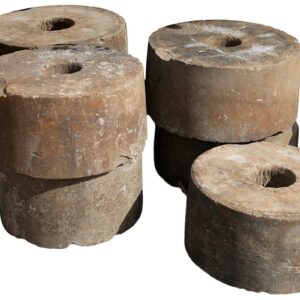 Antique hand carved sandstone millstones with a rich patina of weathered surface and hand tooling marks