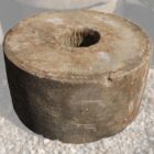 Antique hand carved sandstone millstones with a rich patina of weathered surface and hand tooling marks