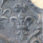 A detail from a cast iron fire back, featuring a Lion Passant, commemorating the 1644 defeat of Royalist forces by a combined Scottish and Parliamentarian army