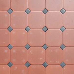 A new, old stock, batch of 12sqm octagonal ferrolite terracotta tiles by Daniel Platt and Sons, in excellent condition