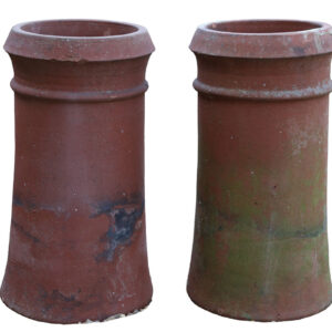 A pair of reclaimed terracotta chimney pots with a cannon top design and consistent weathering.