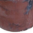 Close up of one of a pair of terracotta cannon top chimney pots showing discolouration from years of use