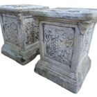 A pair of weathered composite stone plinths showing a light patina of lichen and mild discolouration, perfect for small courtyards and gardens