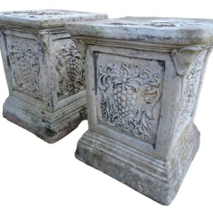 A pair of weathered composite stone plinths showing a light patina of lichen and mild discolouration, perfect for small courtyards and gardens