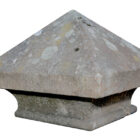 A weathered raised Yorkstone pier cap with patches of lichen and aged patina