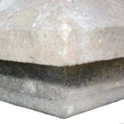Detail of the curved, raised upstand on a weathered Yorkstone pier cap