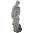 The reverse side of a weathered statue of Aphrodite holding a dove, in composite stone with a subtle height of 84cm