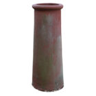 A tall red roll top chimney pot with a weathered patina
